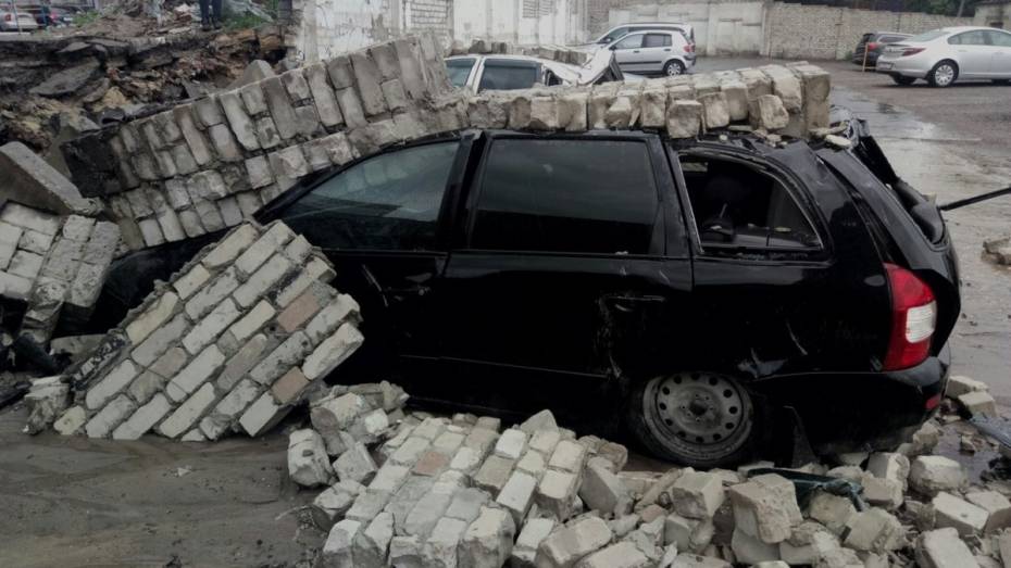 В Воронеже во время грозы кирпичный забор стоянки упал на припаркованные машины